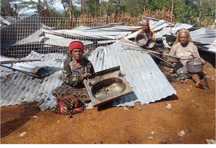 Women with destroyed houses